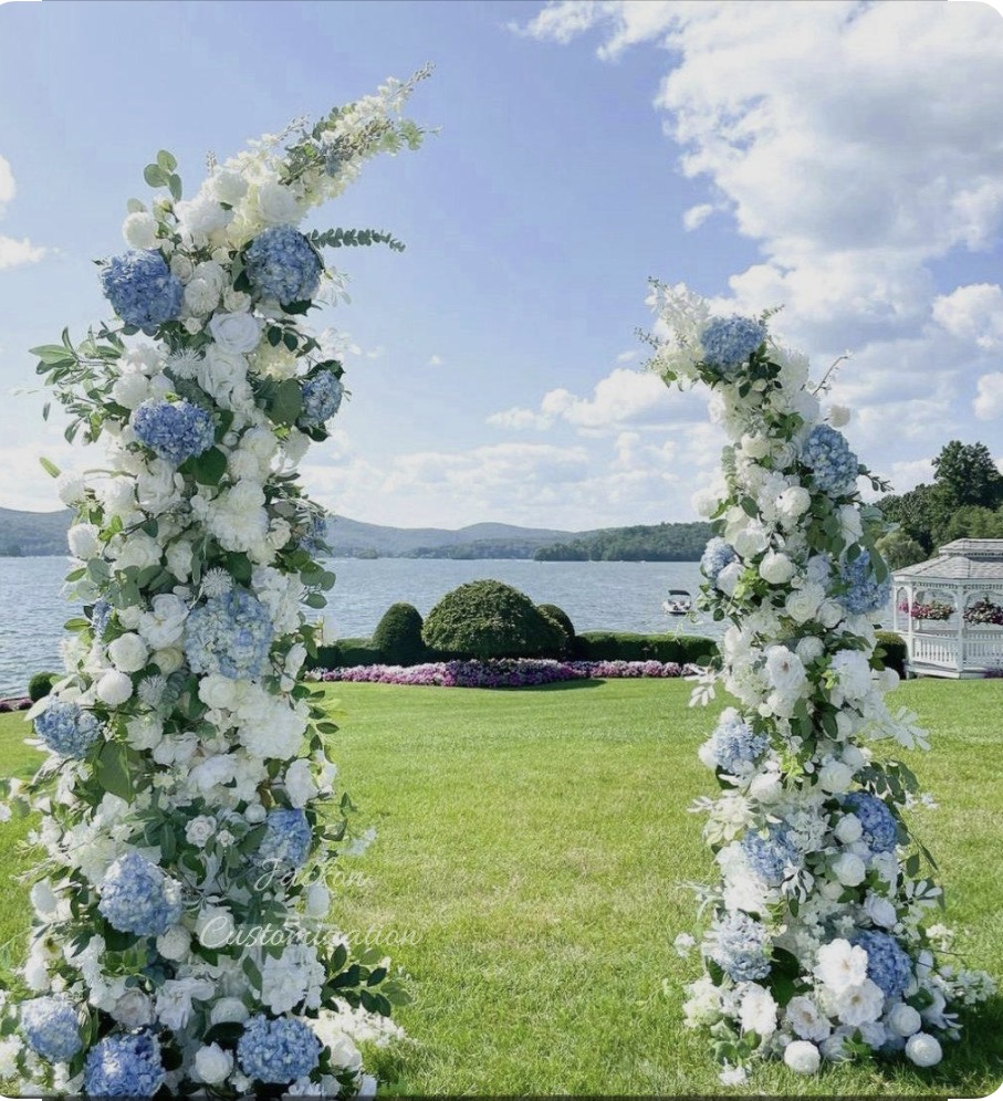 Blue and white floral arch by the lake
