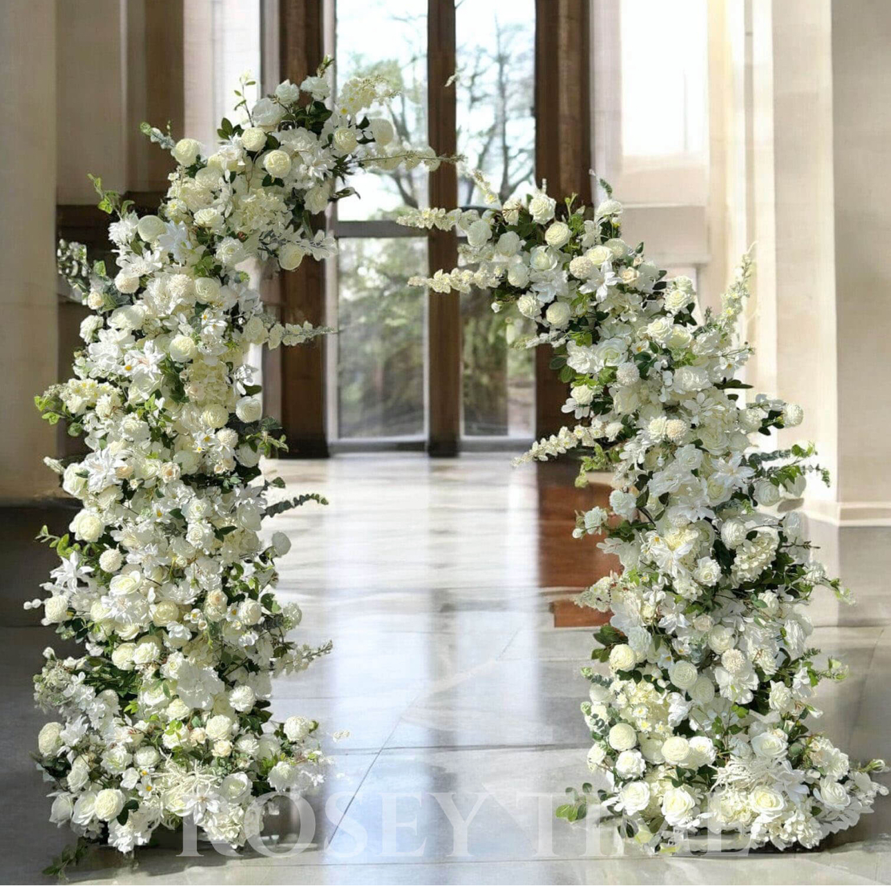 All-white floral arch in grand marble hall