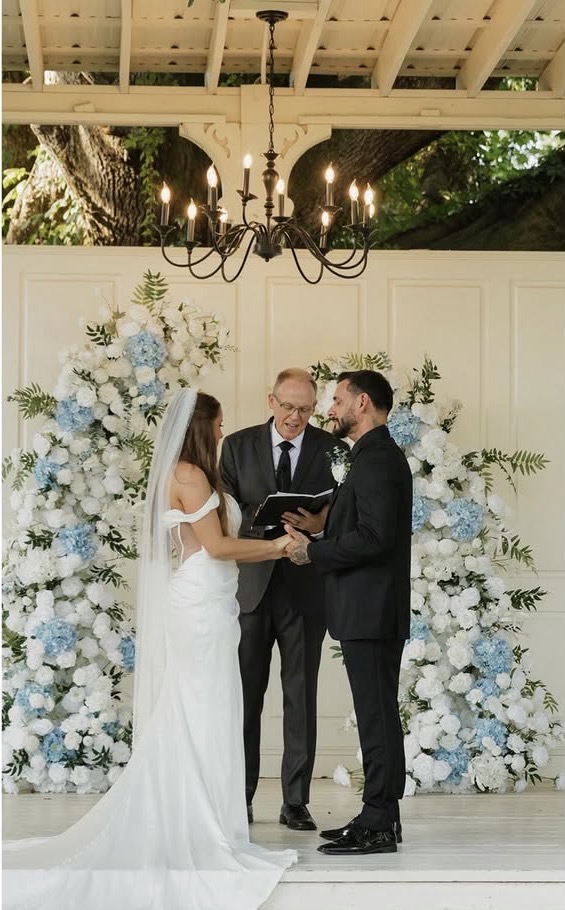 Wedding ceremony arch with blue and white hydrangeas