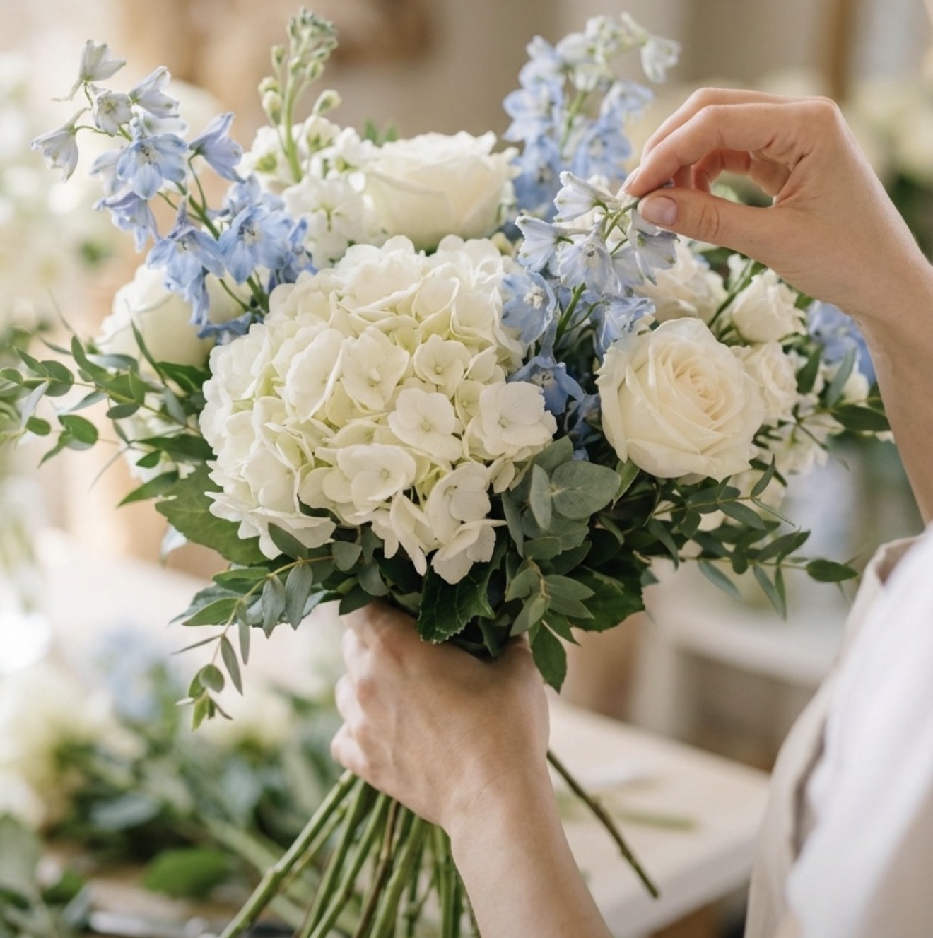 Blue and white hydrangea bouquet being arranged